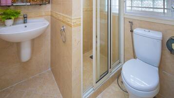 A bathroom with a sink, toilet, and shower.