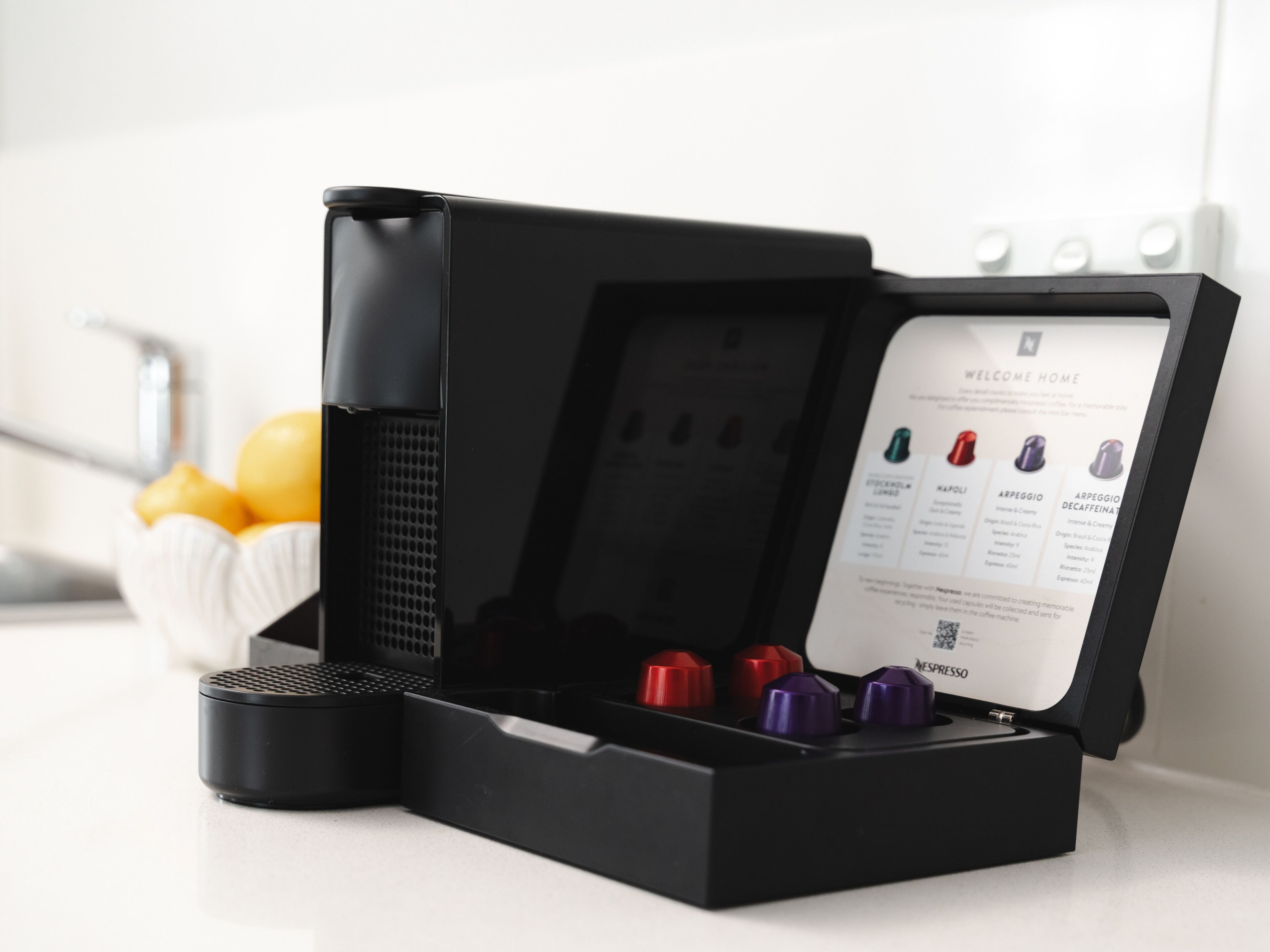 A coffee machine with a display panel and a coffee pod holder.