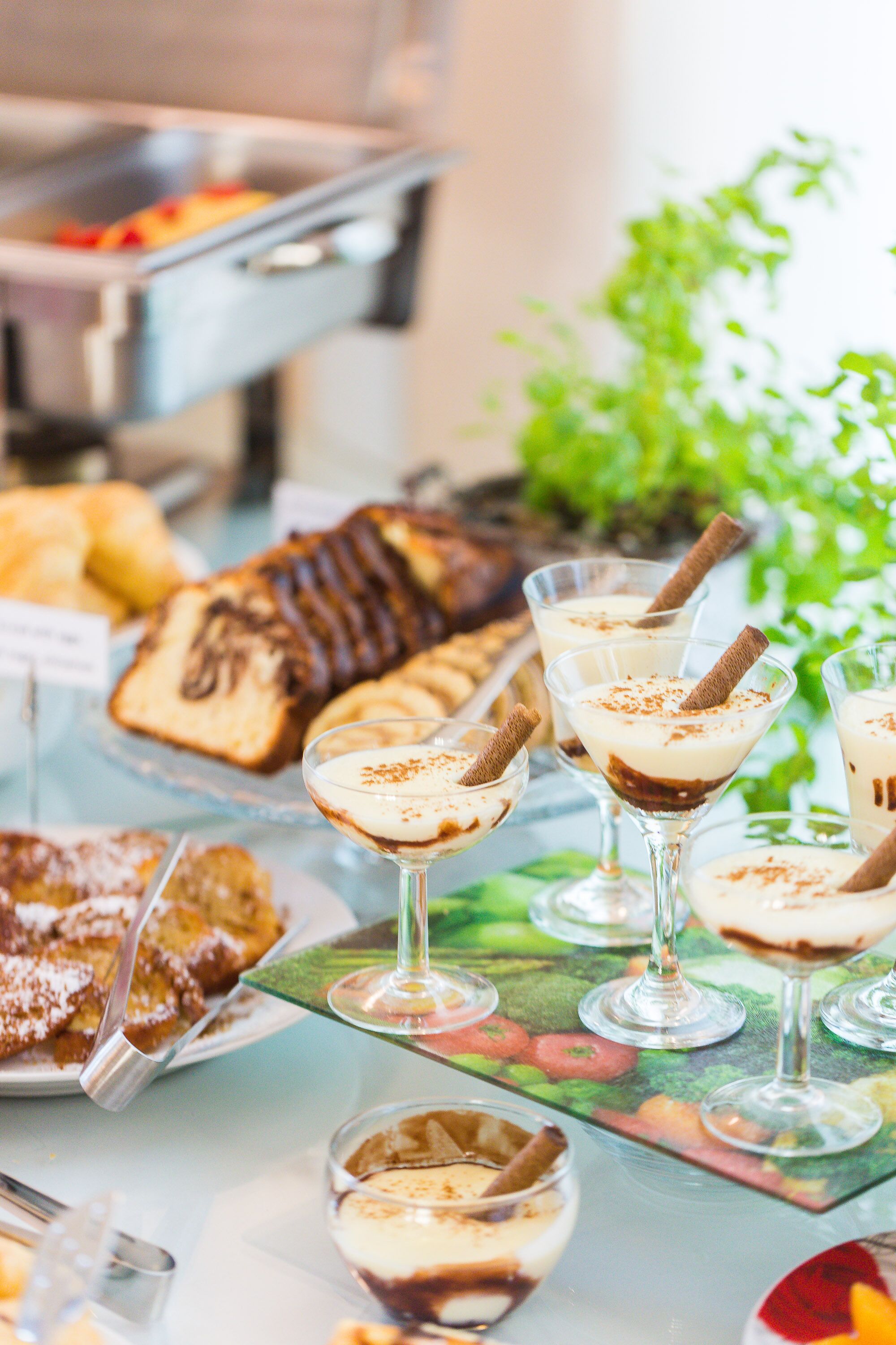 A buffet with various desserts and beverages.