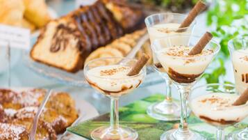 A buffet with various desserts and beverages.