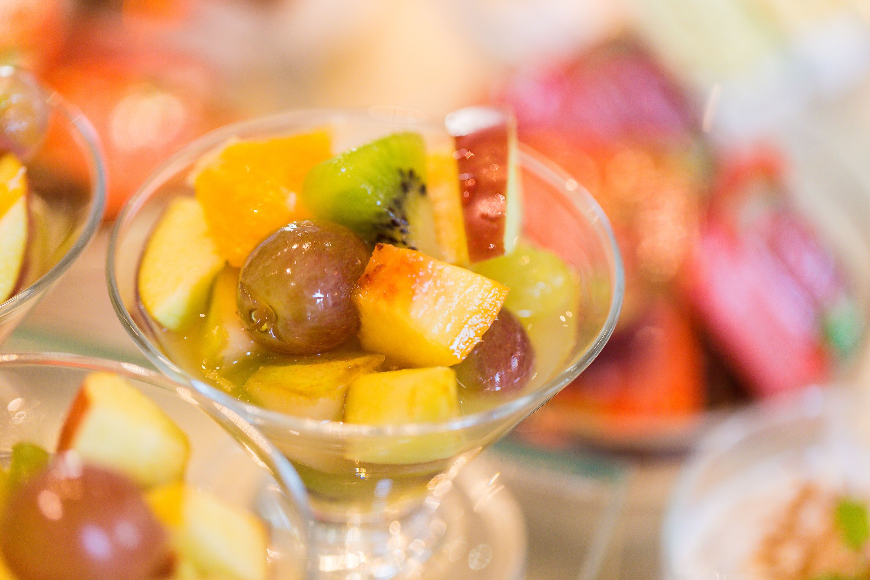 A dessert with various fruits in a glass bowl.