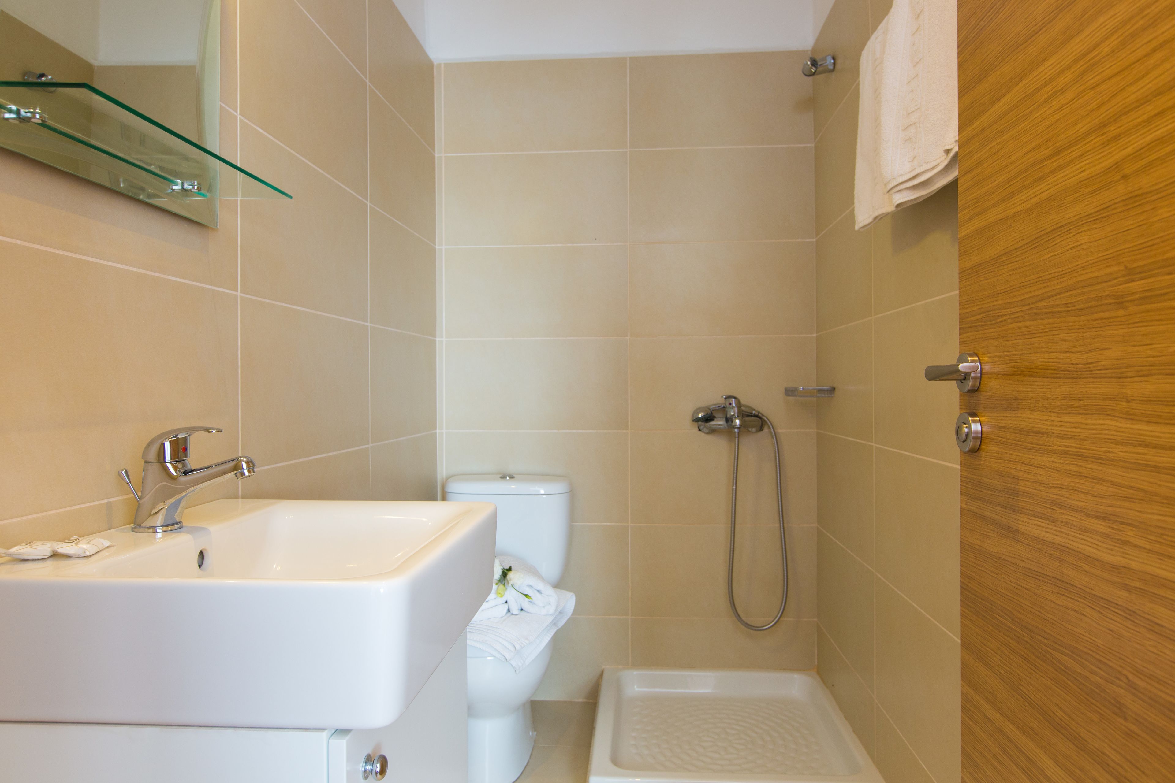 A bathroom with a sink, toilet, and shower.
