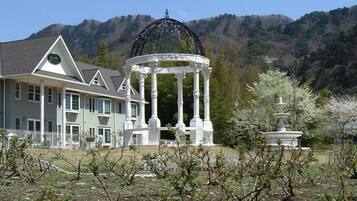 A large house with a gazebo in the garden.