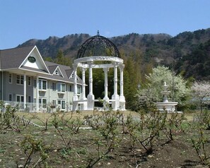 A large house with a gazebo in the garden.