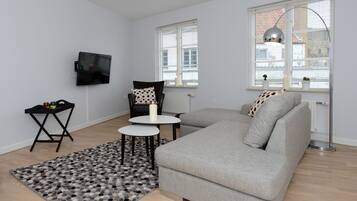 City Apartment, 1 Bedroom | Living room | 28-inch flat-screen TV with cable channels, TV, offices