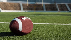 A football on a grassy field with a goalpost in the background. - Holiday Inn Express & Suites Toledo South - Perrysburg by IHG (Perrysburg)