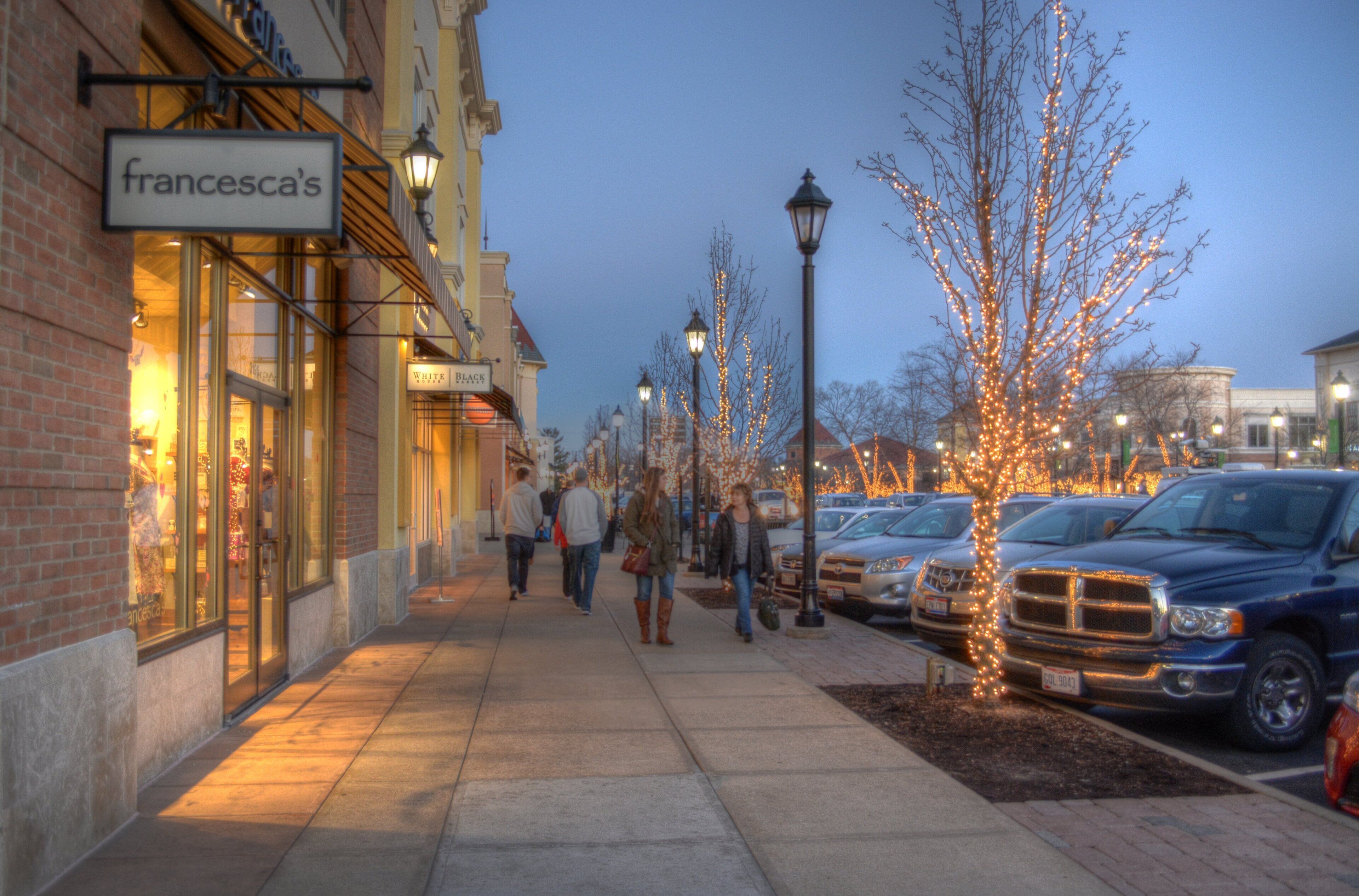 A sidewalk lined with shops, including a visible storefront with a sign that reads 'francesca's.'