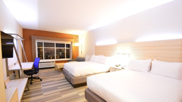 A hotel room with two beds, a desk, a chair, a TV, and a window with a city view. - Holiday Inn Express & Suites Toledo South - Perrysburg by IHG (Perrysburg)