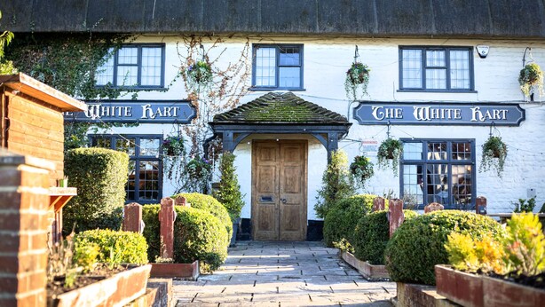 A traditional building with a sign reading "The White Hart."