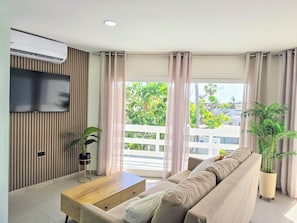 Apartamento Deluxe | Zona de estar | Smart TV de 32 pulgadas con canales por cable