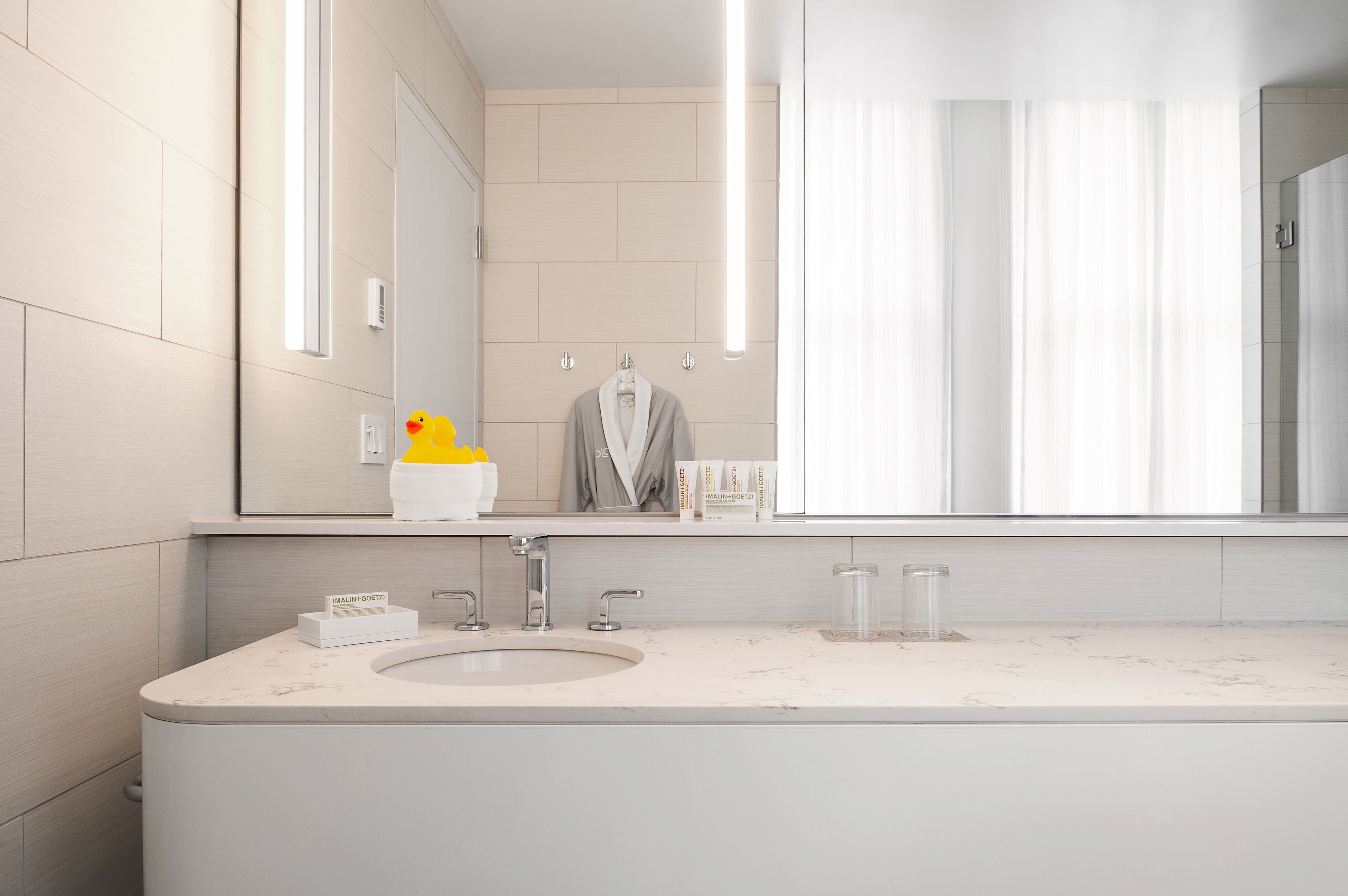 designer toiletries, hair dryer, bathrobes, slippers