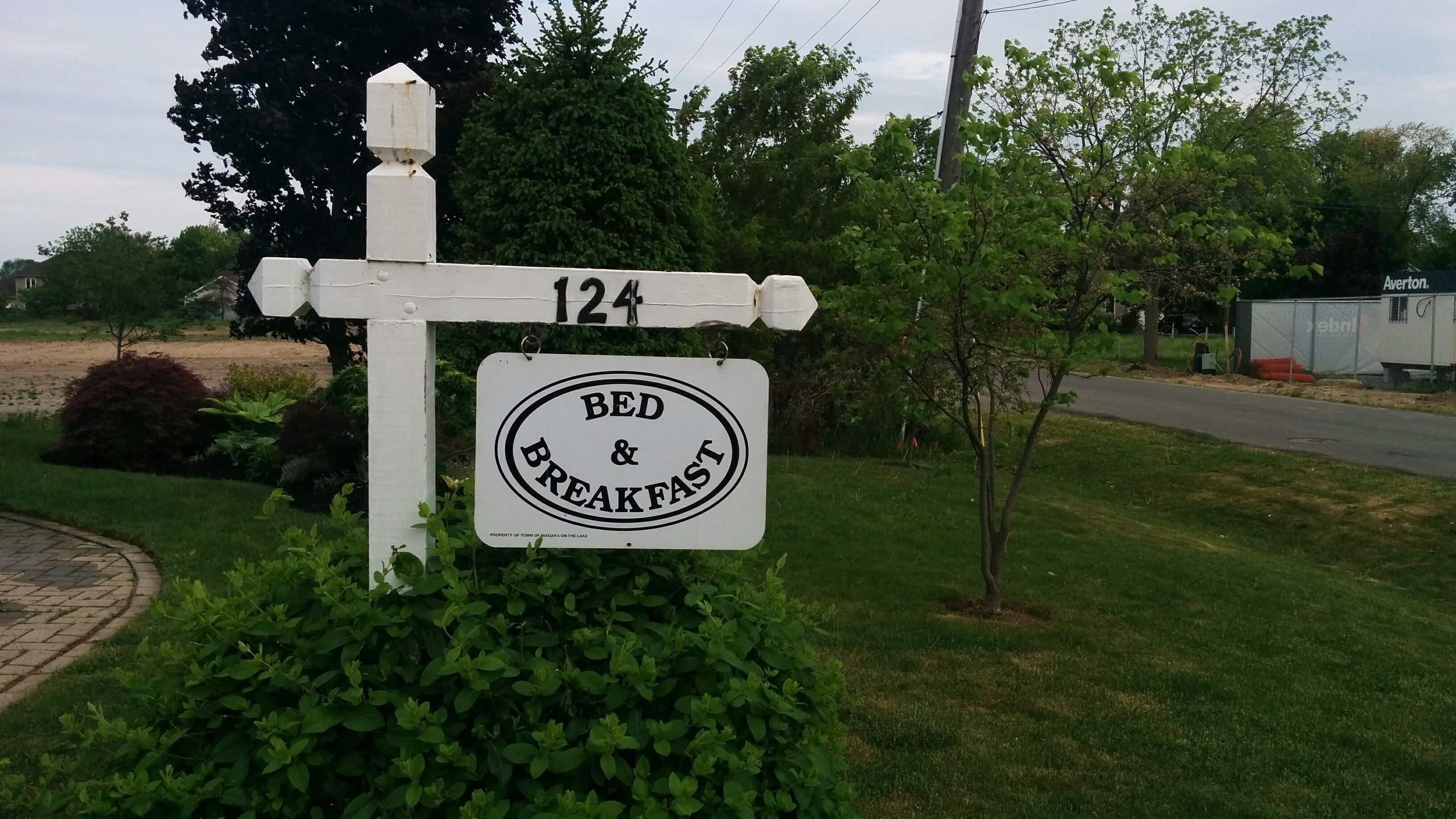 A sign for a bed and breakfast with a directional arrow pointing to the right.
