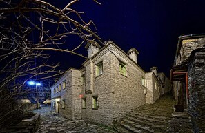 A stone building with multiple windows and a staircase leading up to it. - Aithrio Guesthouse (Zagori)