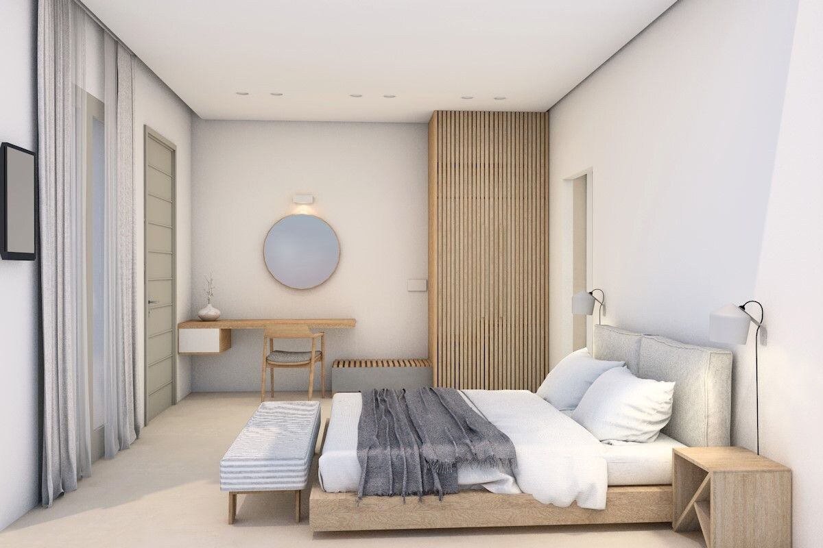A modern bedroom with a bed, bedside table, and a wall-mounted lamp.