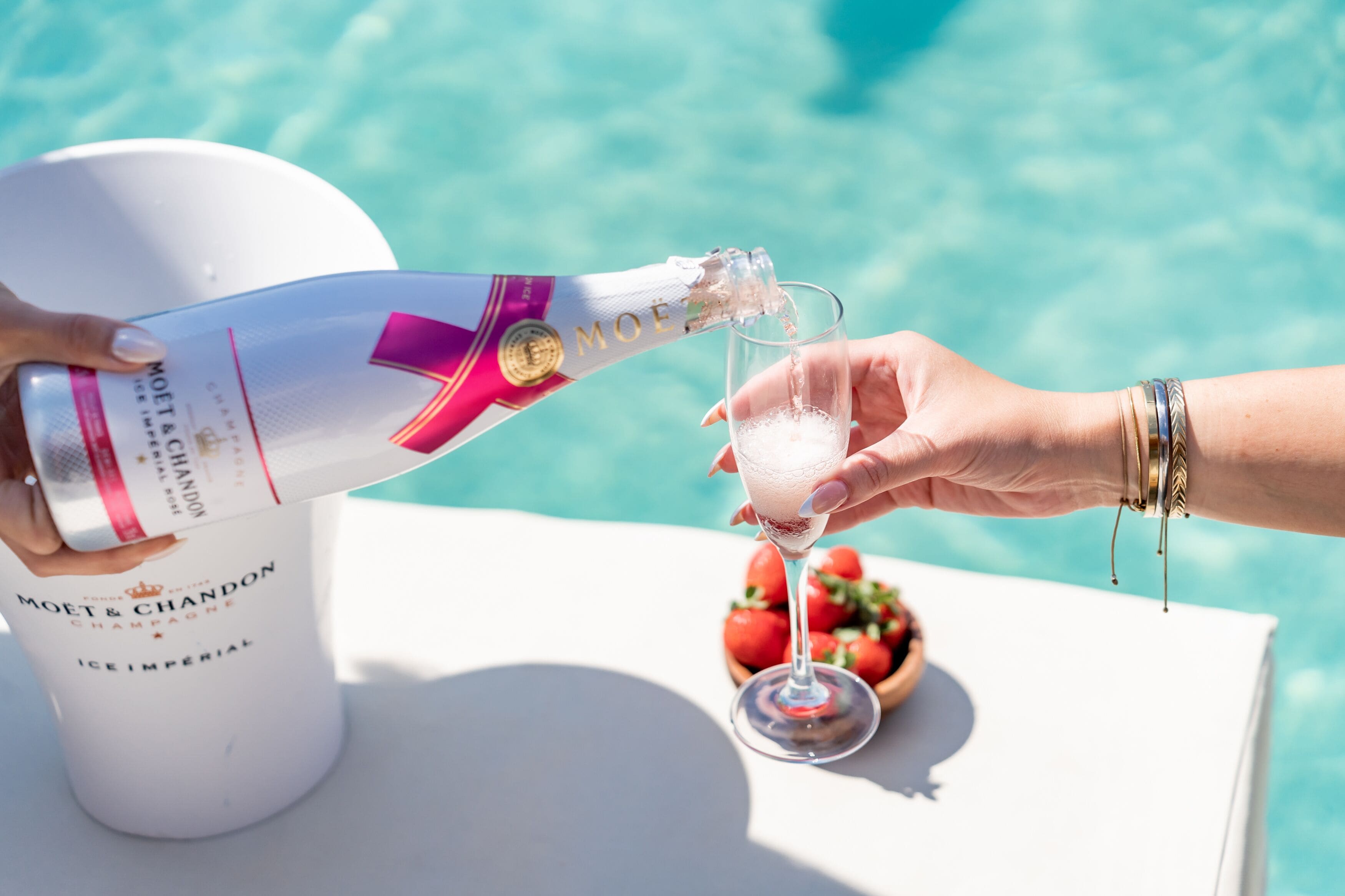 A bottle of Moet & Chandon Champagne being poured into a glass.