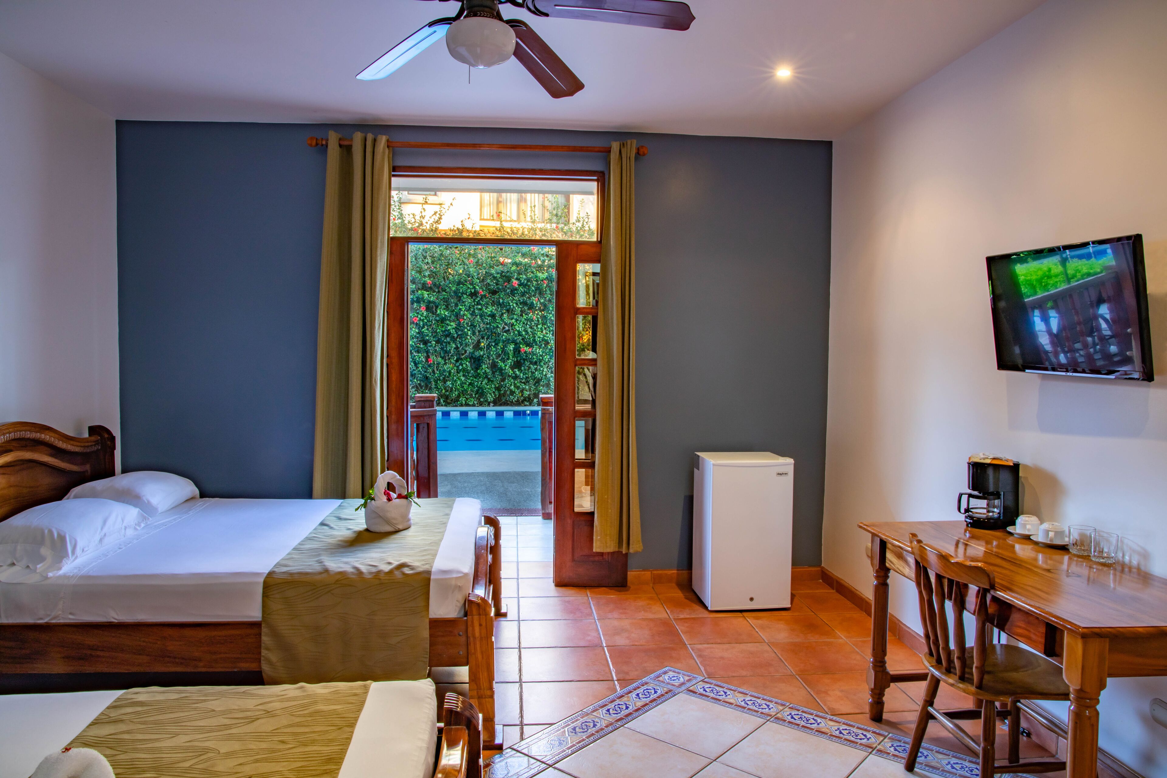 deluxe double room, 2 queen beds, partial ocean view, poolside | in-room safe, desk, free wifi, bed sheets