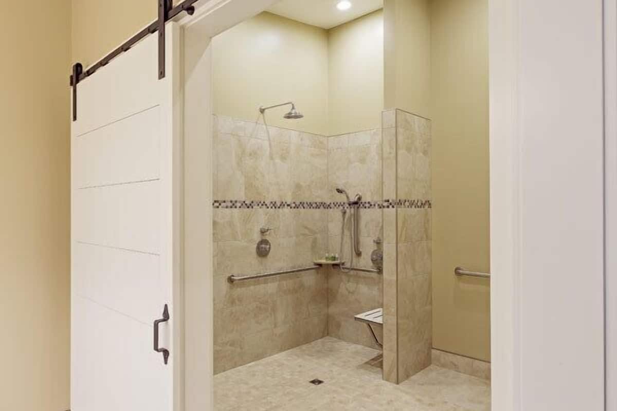 A bathroom with a shower, toilet, and sink.