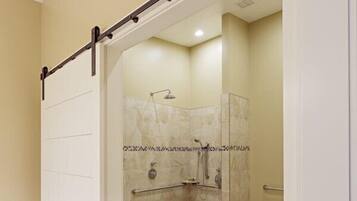 A bathroom with a shower, toilet, and sink.