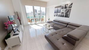 Deluxe Penthouse, 3 Bedrooms | Living room | 50-inch flat-screen TV with cable channels, TV