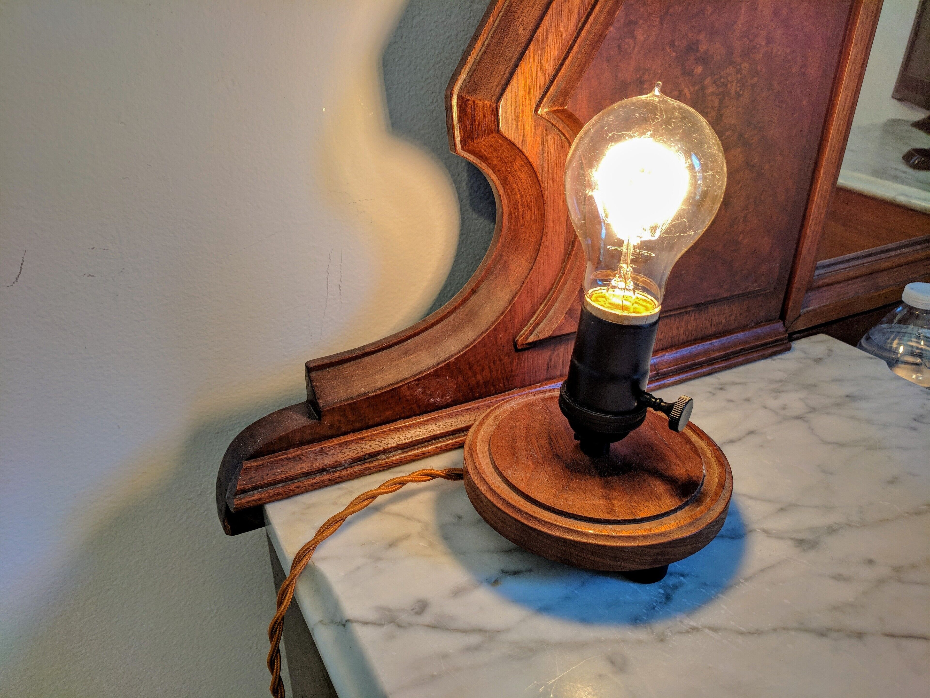 A vintage-style light fixture on a marble countertop.