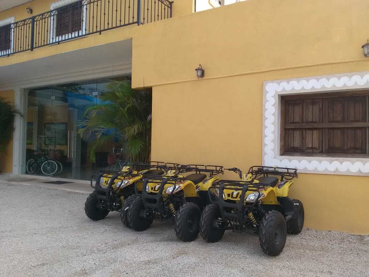 A building with a yellow exterior and a balcony.