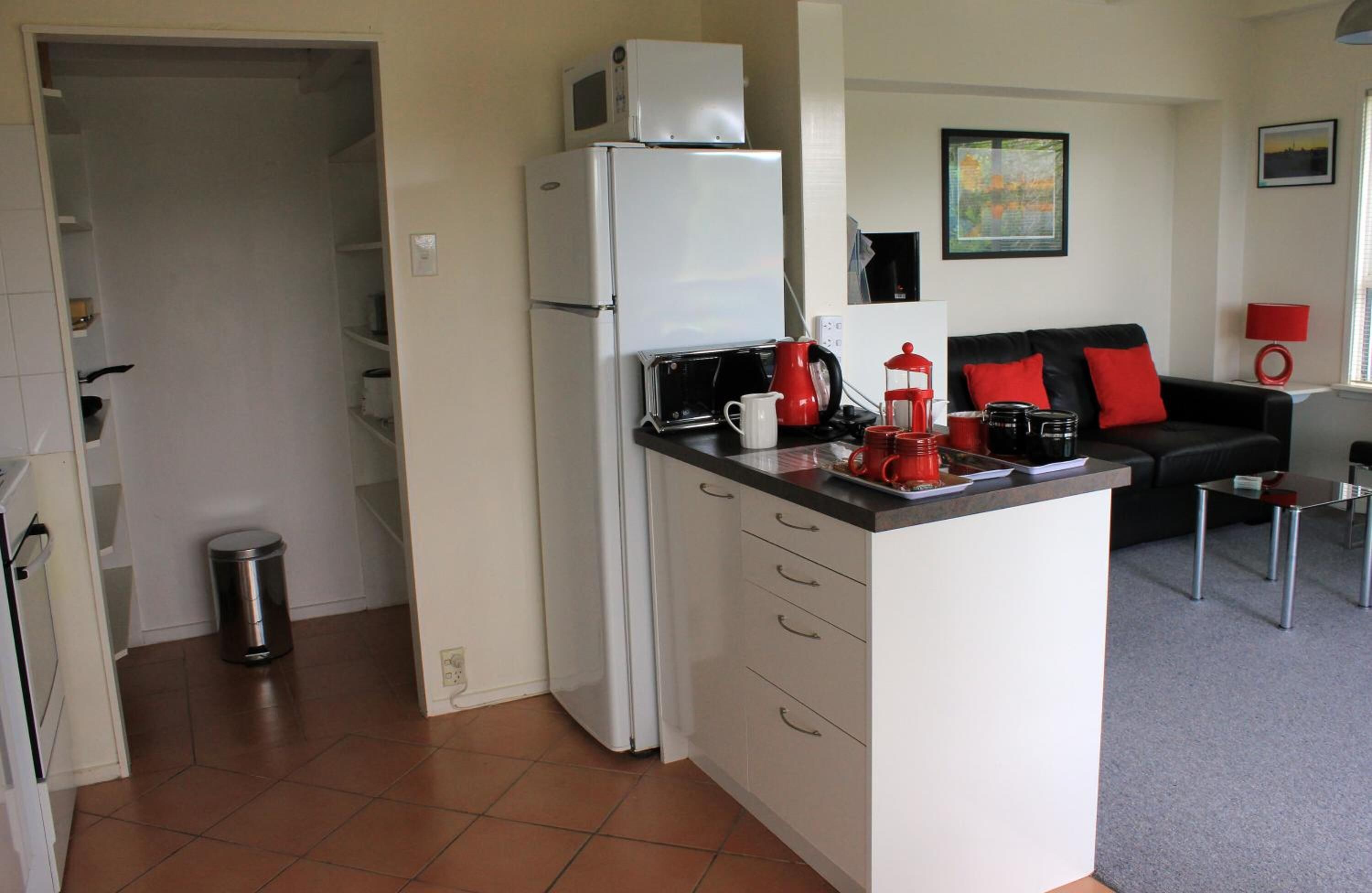 full-sized fridge, microwave, stovetop, coffee/tea maker