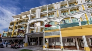 A multi-story hotel with balconies, a covered entrance, and a visible restaurant sign. - Triple Three Patong (Patong)