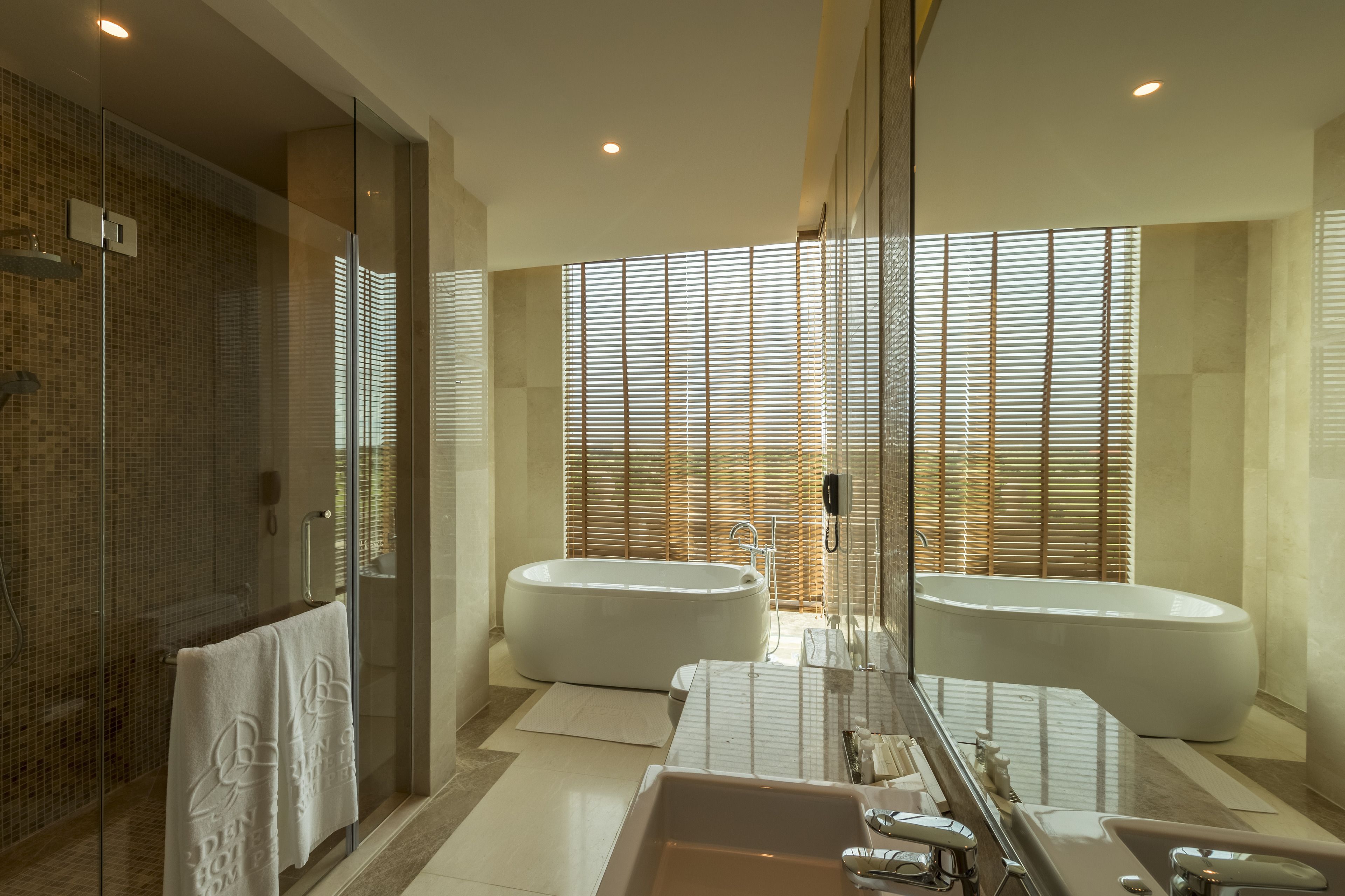 junior suite | bathroom | combined shower/bathtub, free toiletries, hair dryer, dressing gowns