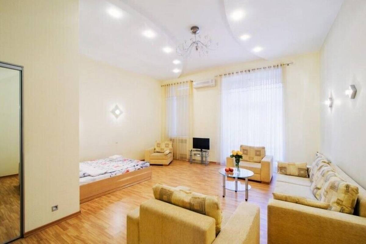 A spacious living room with a sofa set, a coffee table, and a TV.