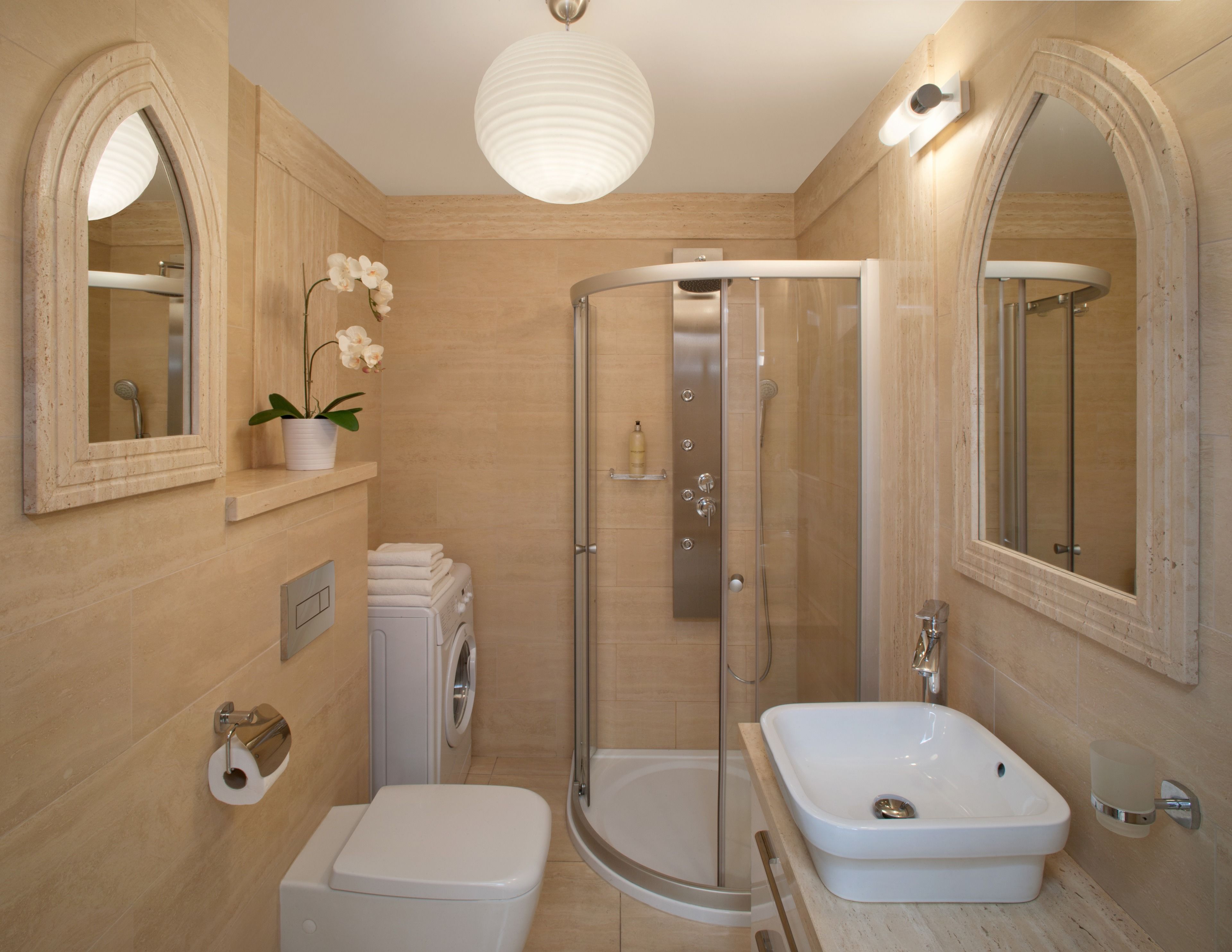 A modern bathroom with a walk-in shower, a freestanding bathtub, a toilet, and a sink.