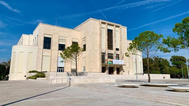 A modern building with a symmetrical facade, large windows, and a central entrance. - Villa Venice Movie (Venice)