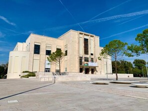 Un edificio moderno con una facciata simmetrica, ampie finestre e un ingresso centrale.