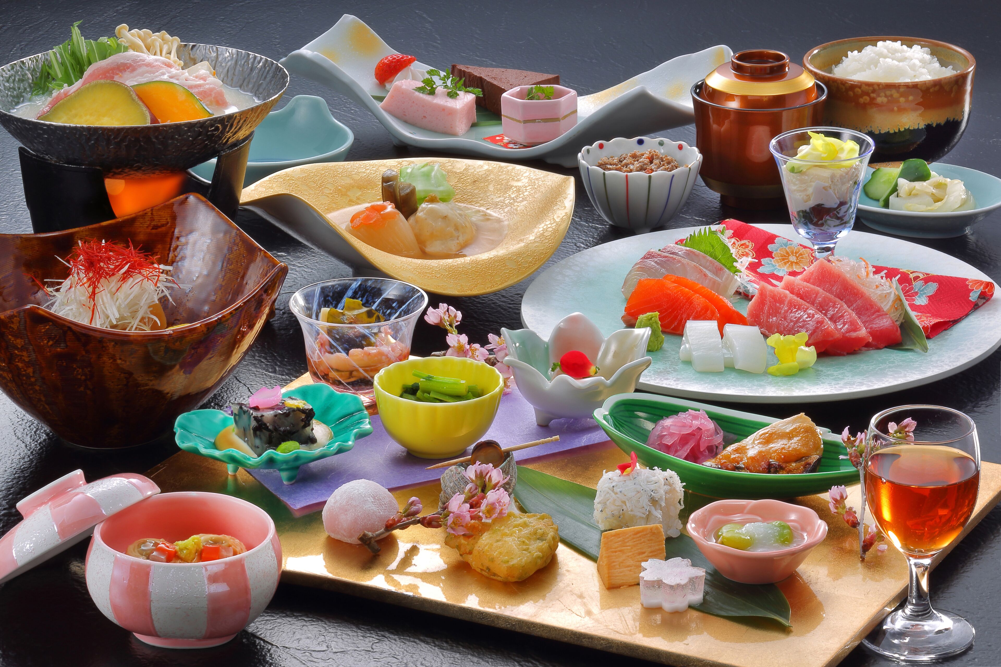 Une variété de plats japonais présentés sur une table, notamment des sushis, des sashimis et d’autres plats traditionnels.