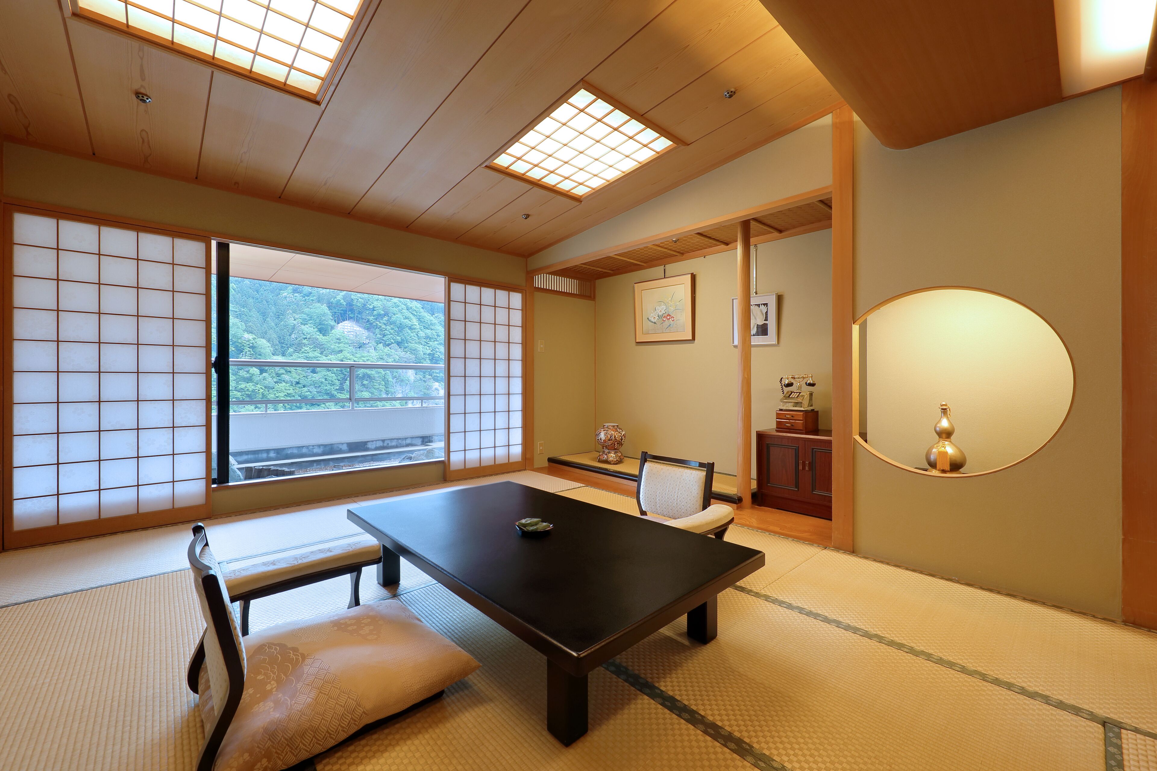 A traditional Japanese room with tatami flooring, a low table, and sliding doors.