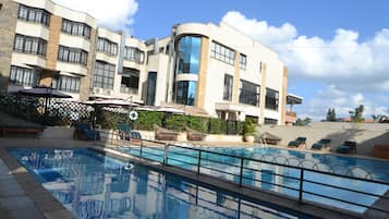 Outdoor pool, pool umbrellas, lifeguards on site