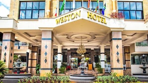 The Weston Hotel entrance with a central fountain, columns, and flags. - Weston Hotel (Nairobi)