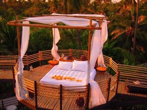 A bed with a canopy in a tropical setting. - Bangkok Tree House (Phra Pradaeng)