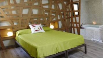A bedroom with a wooden headboard, a bed with a green bedspread, bedside lamps, and a small table with a lamp.