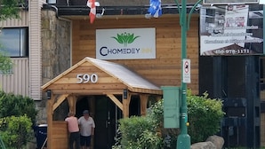A wooden building with a sign reading "Chomedey Inn" and the number "590" on the front.