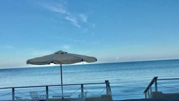 Private beach, white sand, beach umbrellas, sailing