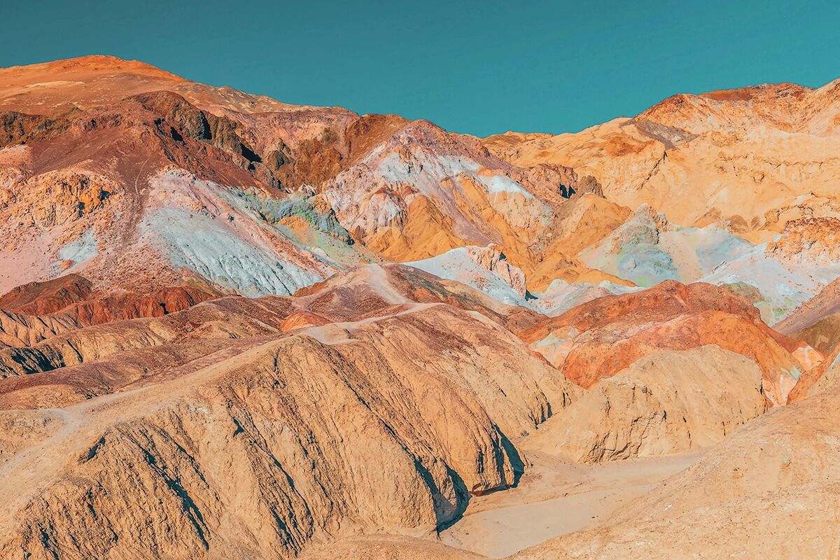 A rugged, multi-colored mountain landscape with distinct geological formations.