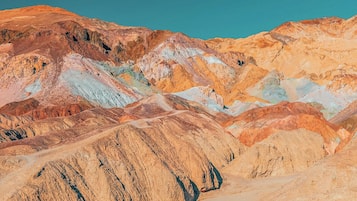 A rugged, multi-colored mountain landscape with distinct geological formations.