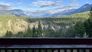 A mountainous landscape with dense forests and a clear sky. - Radium Chalet (Radium Hot Springs)