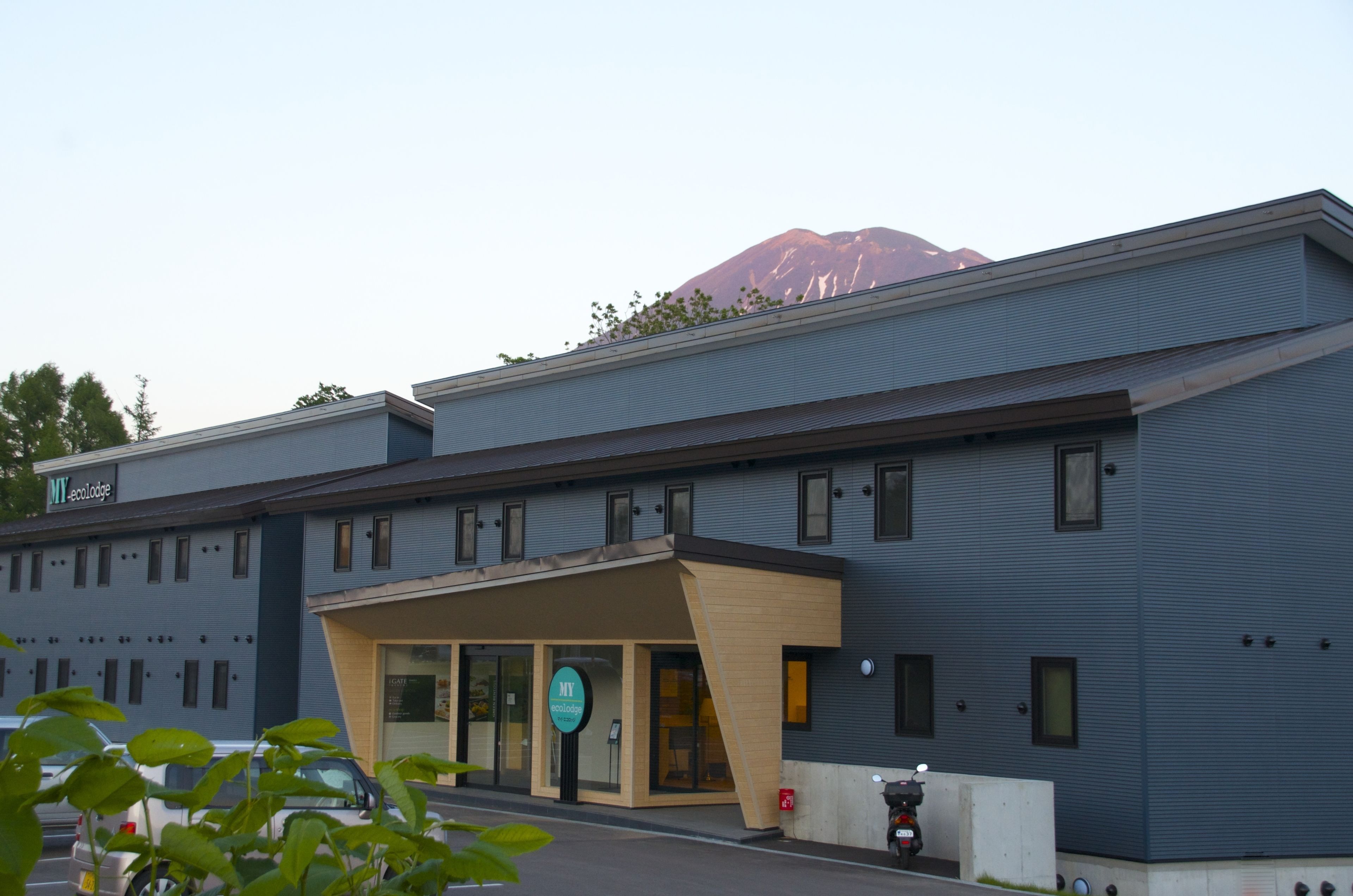 A modern building with a flat roof and a large entrance.