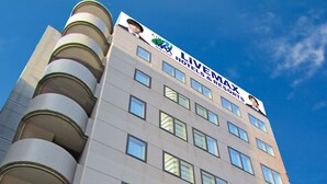 A hotel building with a modern design, featuring a prominent 'HOTEL LIVEMAX' sign at the ground level. - HOTEL LiVEMAX Sapporo-Ekimae (Sapporo)