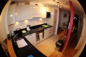 Apartment, 4 Bedrooms | Private kitchen | Full-size fridge, microwave, stovetop, dishwasher