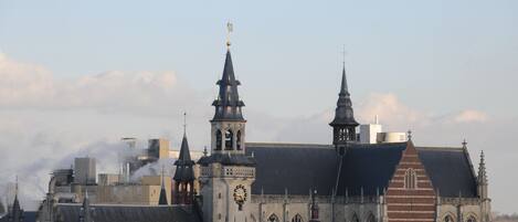 A historic building with multiple spires and a prominent clock tower.