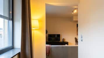 Una sala de estar moderna con un sofá, un televisor y una lámpara.