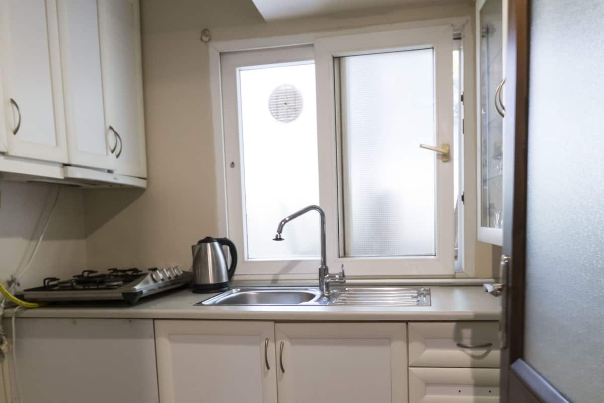 Economy Apartment, Garden Area | Private kitchen | Fridge, stovetop, coffee/tea maker, electric kettle
