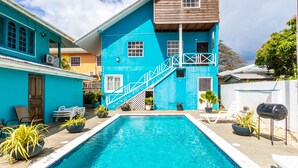 A two-story building with a pool in front.